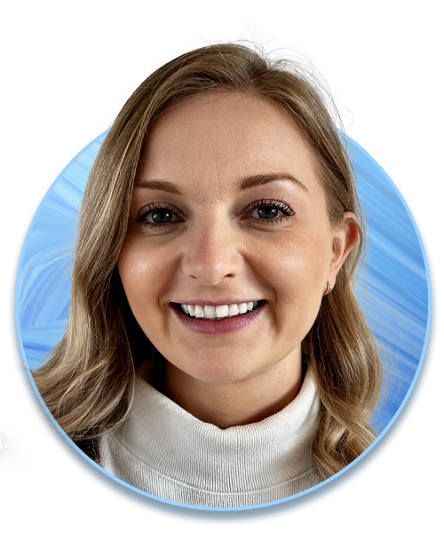 A woman with long, wavy blonde hair smiles warmly, wearing a white turtleneck. She is presented in a circular frame against a soft blue background.